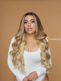 Long wavy blonde wig with center part and darker roots, voluminous curls