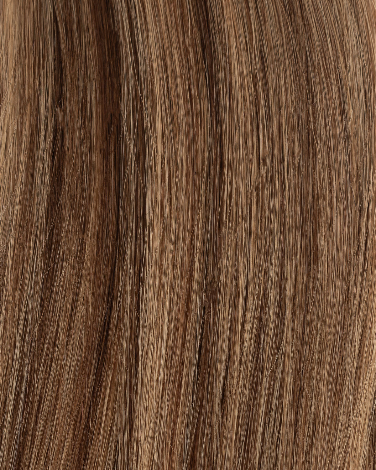 Caramel blend hair extension strands, close-up with subtle highlights