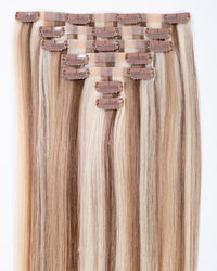 Blonde blend seamless clip-in hair extensions showing multiple top clips, straight hair