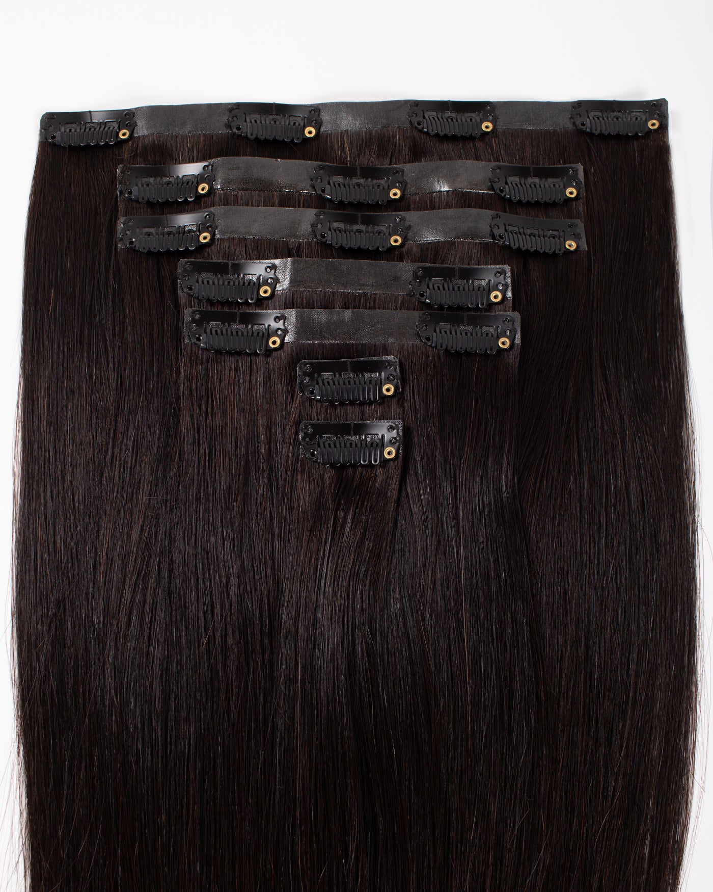 Off-black clip-in hair extensions with multiple rows of snap clips