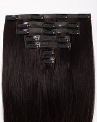 Off-black clip-in hair extensions with multiple rows of snap clips