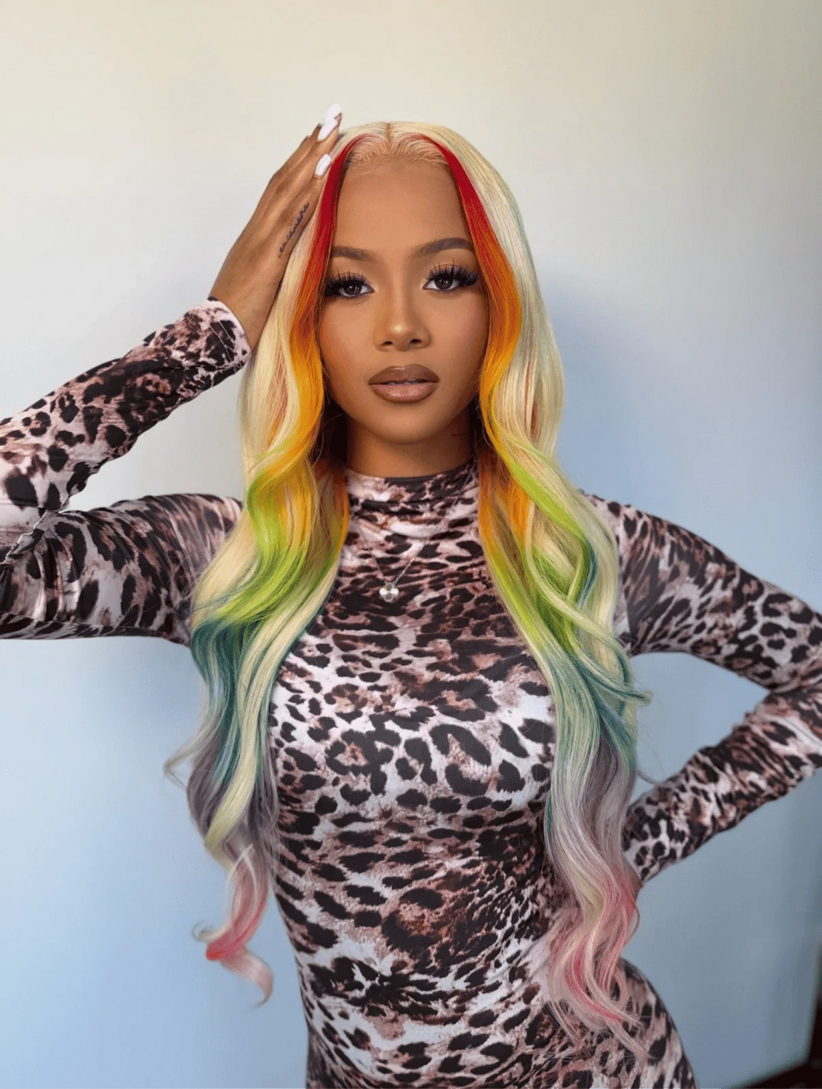 Long wavy pastel lace wig with blonde hair, red roots, and green-blue tips