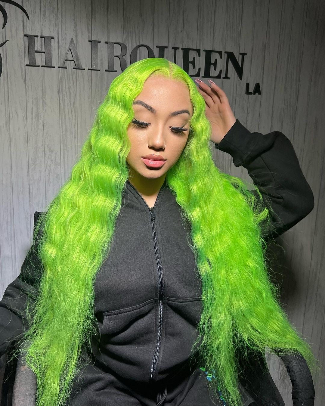 Lime green wig with voluminous waves and full coverage, hand near the part