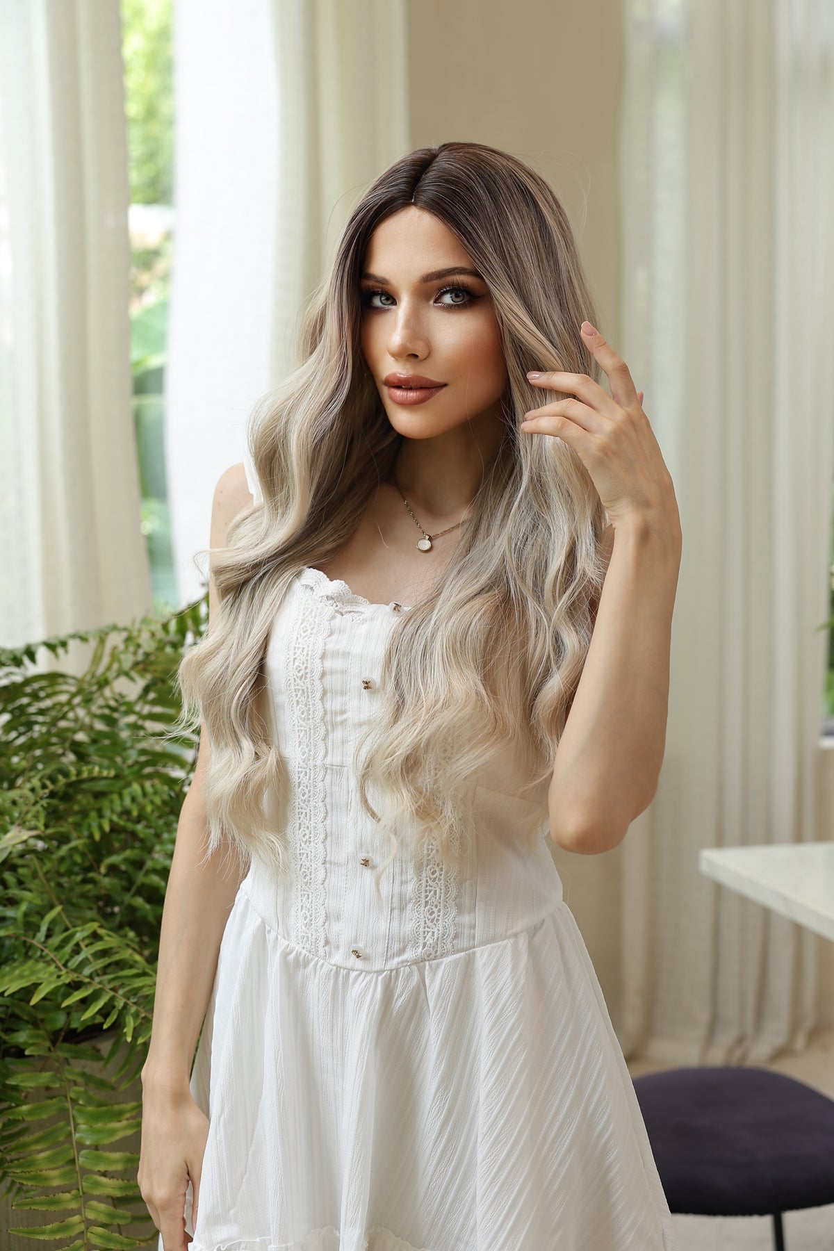 Long wavy blonde wig with darker roots and light highlights, center part