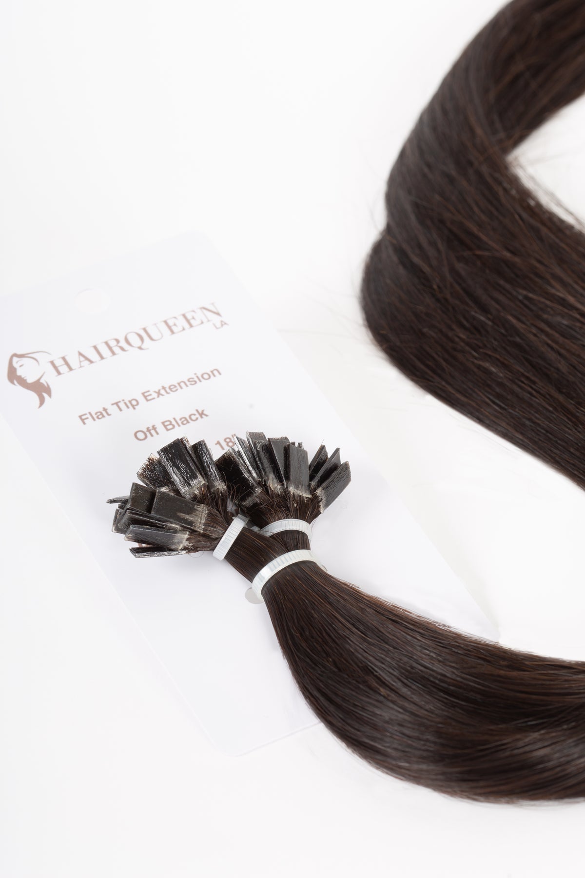 Off-black k-tip hair extension strand with small fused tips and silky hair
