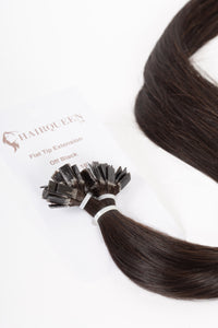 Off-black k-tip hair extension strand with small fused tips and silky hair