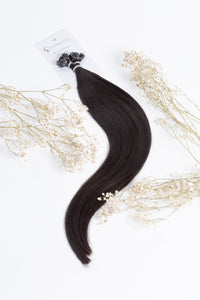 Off-black k-tip hair extensions, two connected strands with visible tips