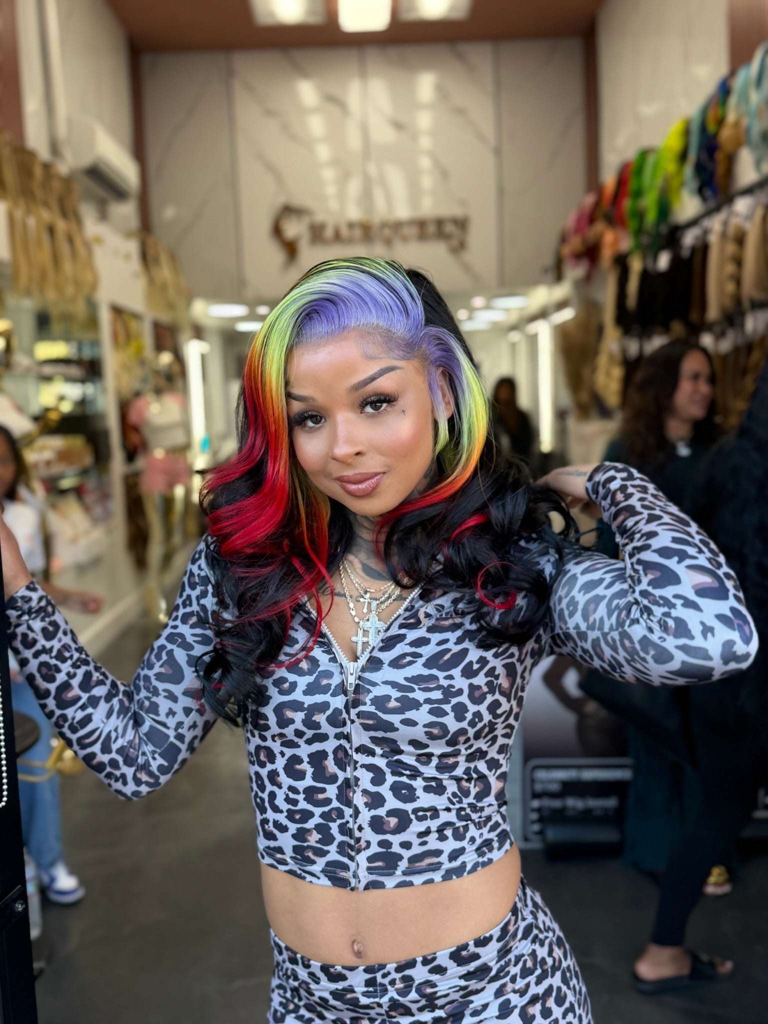 Rainbow lace wig with center-parted wavy hair, black base with red, blue, and green highlights