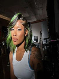 Long wavy dark wig with neon green highlights and side-swept bangs