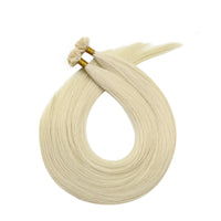 Light blonde hair extension strands with gold-tipped loops for attachment