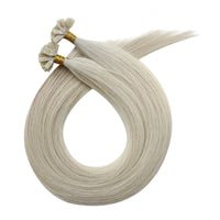 Blonde hair extension strands with gold-tipped loops for attachment