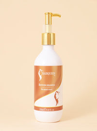 Reviving shampoo bottle with gold pump, white and amber label