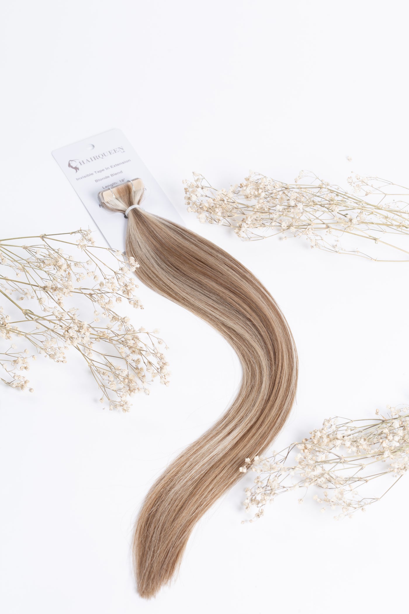 Invisible tape-in hair extension weft in blonde blend with long straight strands and tape