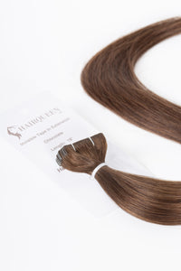 Chocolate brown tape-in hair extension weft with attached tape and card