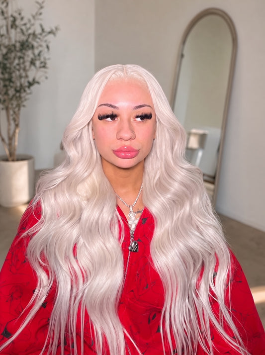Long wavy platinum-silver wig with side-swept bangs and glossy finish