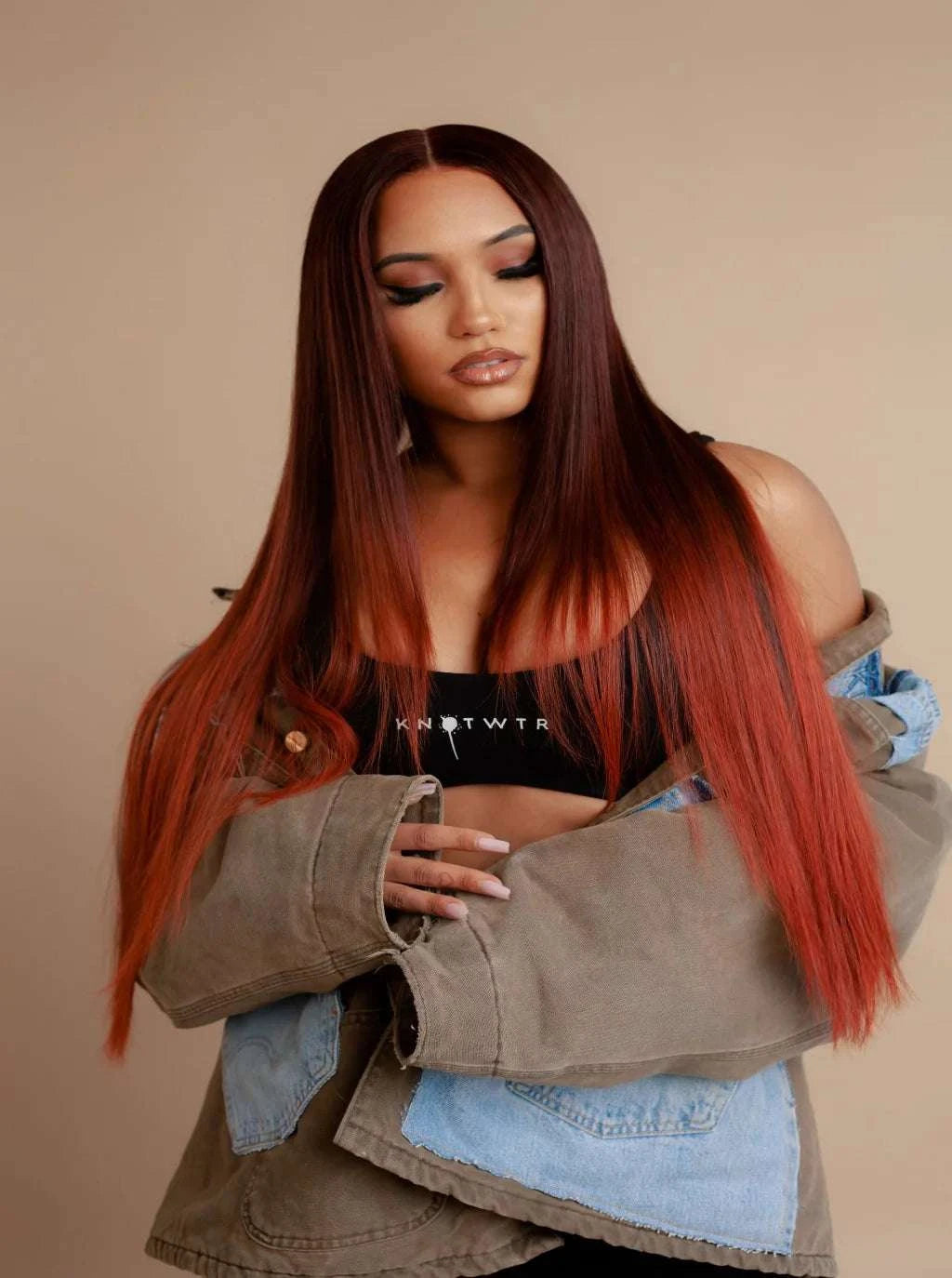 Long straight wig in deep auburn with warm highlights, worn center-part style.