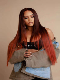 Long straight wig in deep auburn with warm highlights, worn center-part style.