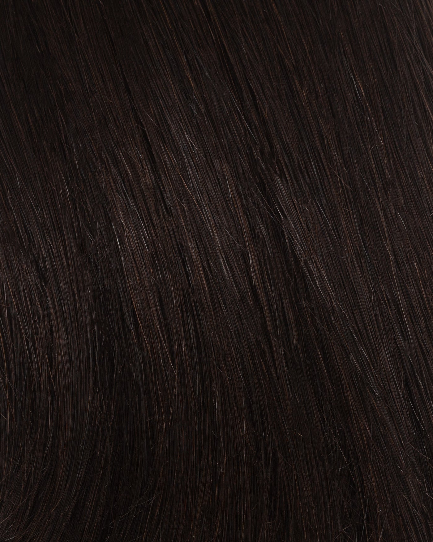 Off-black hair extension close-up showing fine straight strands and texture