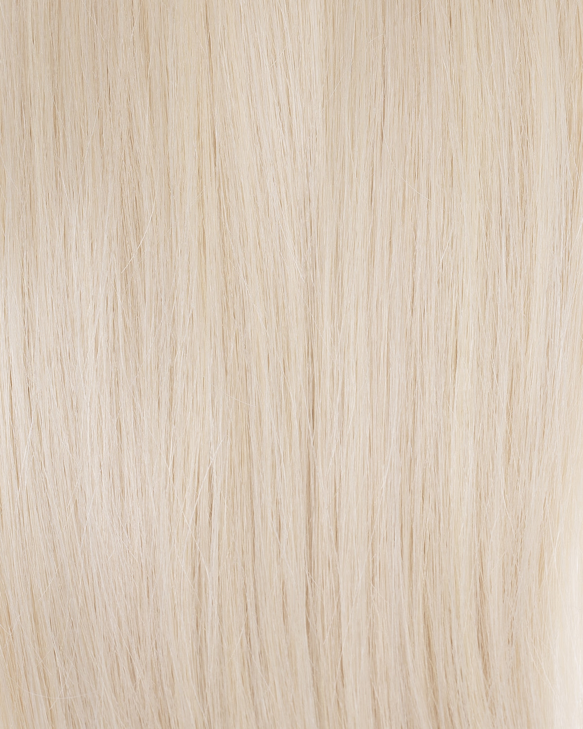 Platinum blonde K-tips hair extensions, close-up of fine straight strands