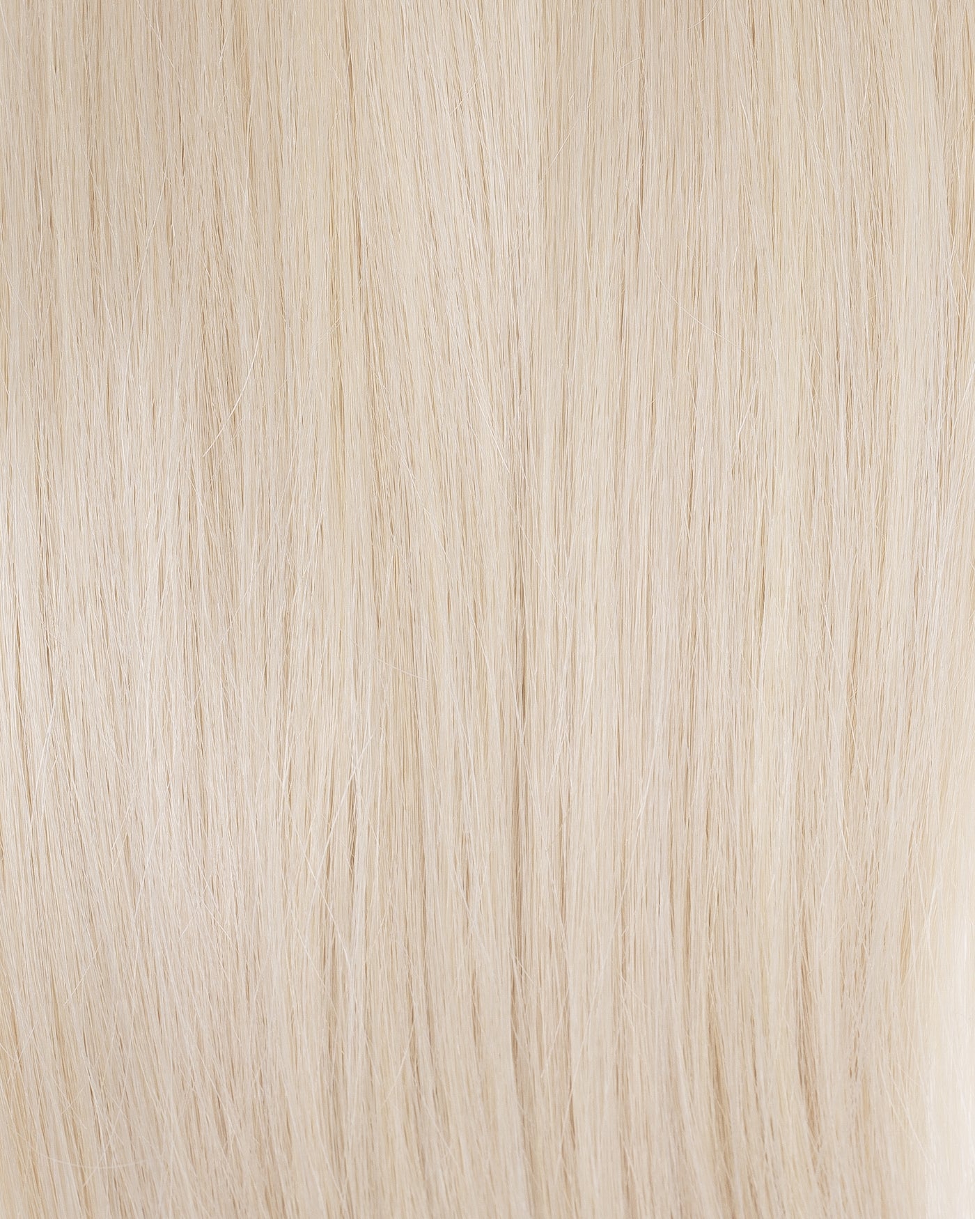 Platinum blonde hair extension close-up with fine straight strands
