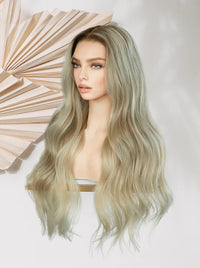 Long wavy wig in sage-ash blonde with layered, flowing waves