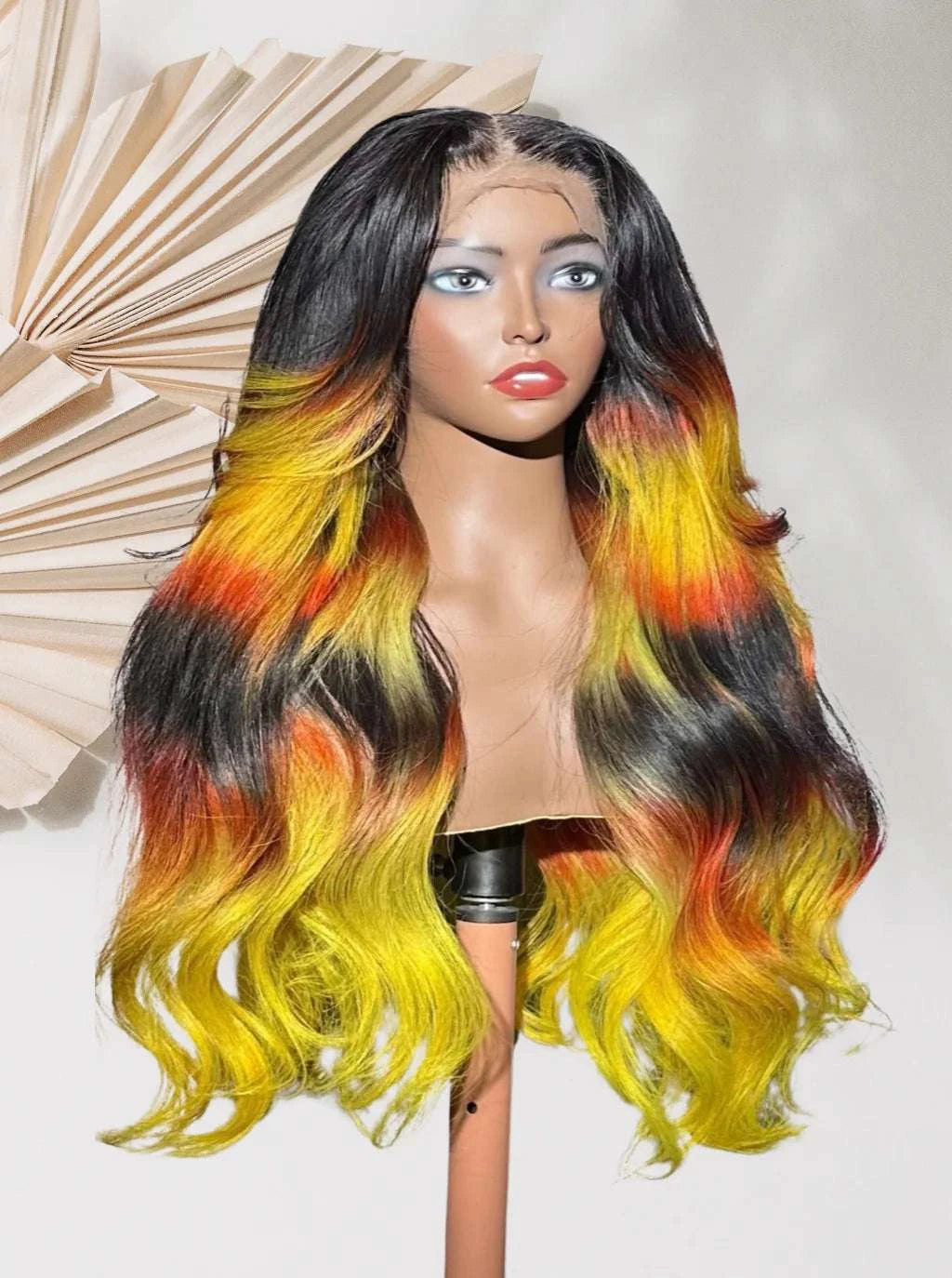 Rainbow ombré lace wig with long wavy black, yellow, orange, and green hair