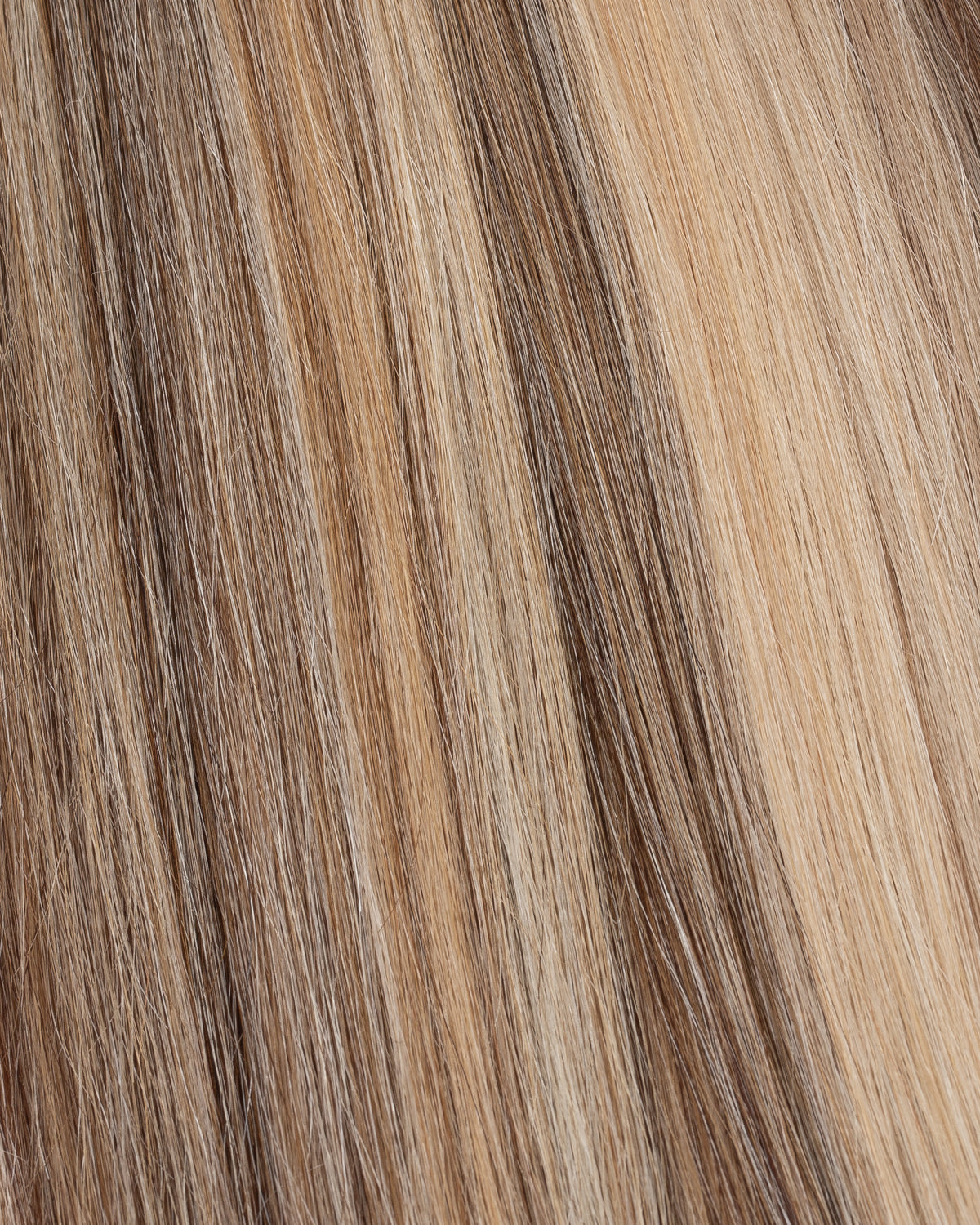 Vanilla swirl hair strands close-up with light blonde and darker brown blend