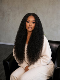 Black curly hair bundle on model, long voluminous curls and natural shine.