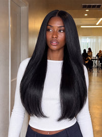 Black straight hair bundle on model, long smooth hair with blunt ends.