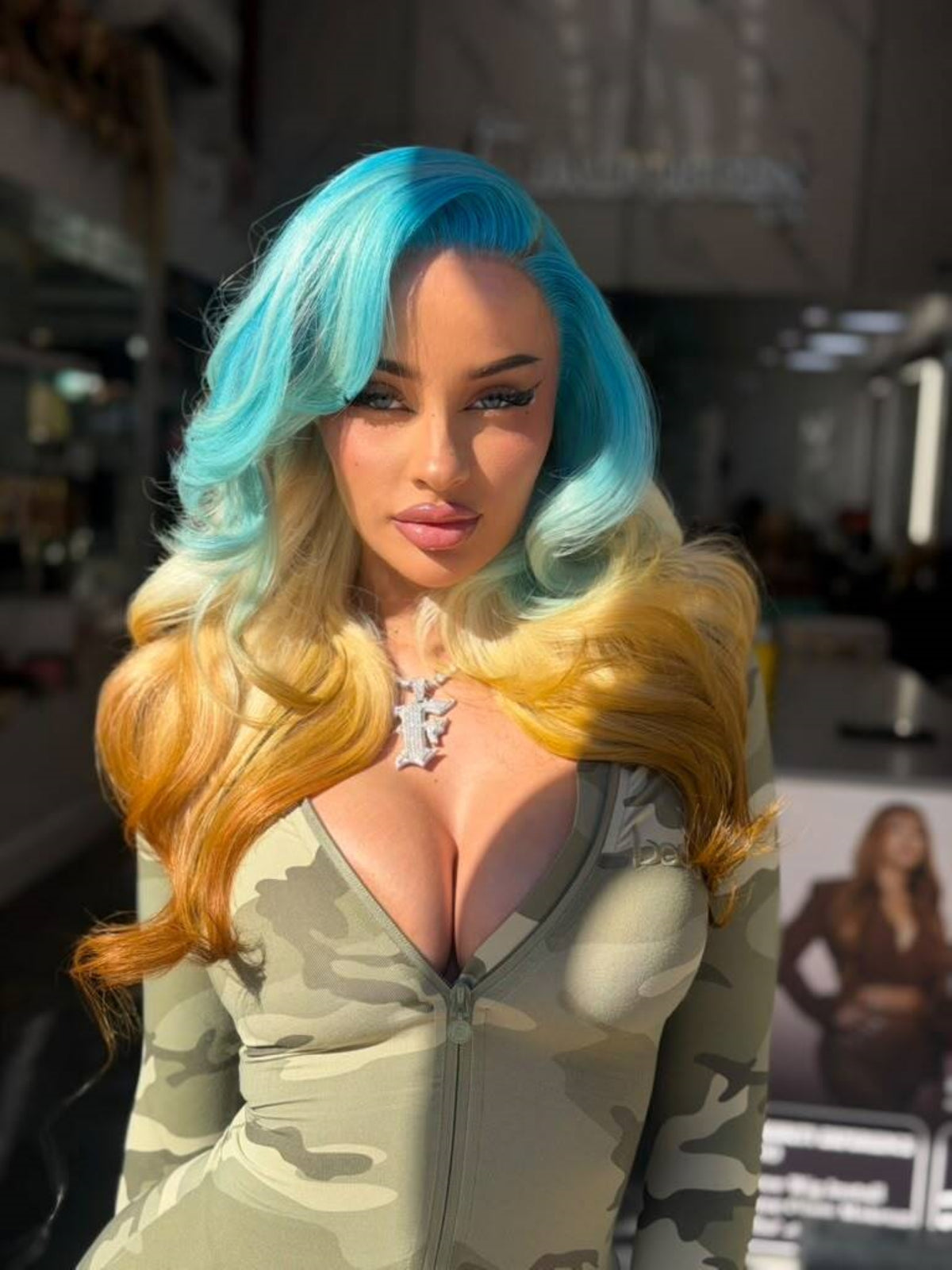 Blue Dream lace wig with long, wavy turquoise, blonde, and golden-orange hair, worn on a model