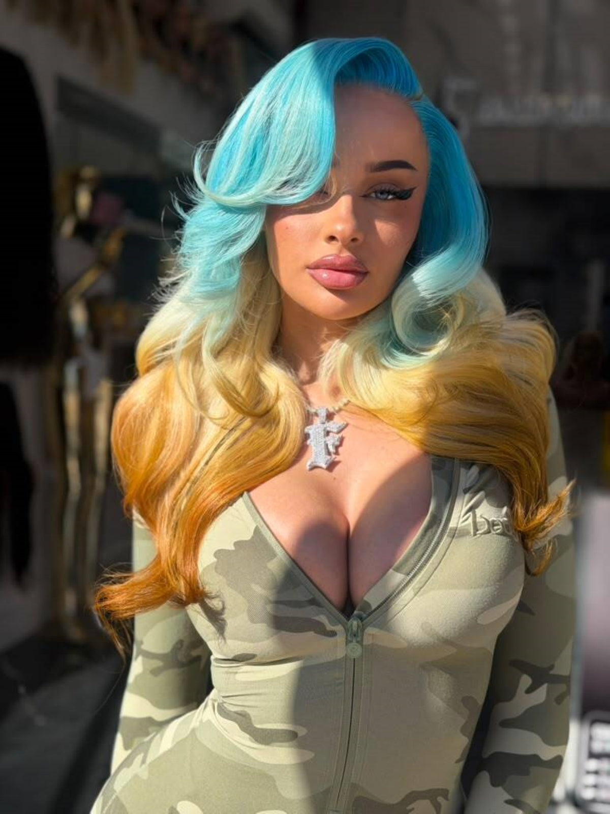 Blue Dream lace wig showing long, wavy turquoise, blonde, and golden-orange hair from the front