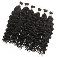 Curly black hair bundles with a thick wave pattern and gold beaded tips