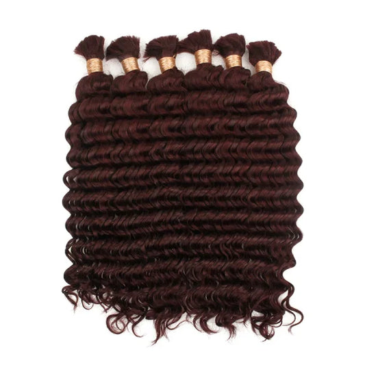 Curly hair bundle in deep burgundy with visible wefts and short loose curls