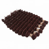 Curly hair bundle in deep burgundy, angled view with gold-lined weft ends