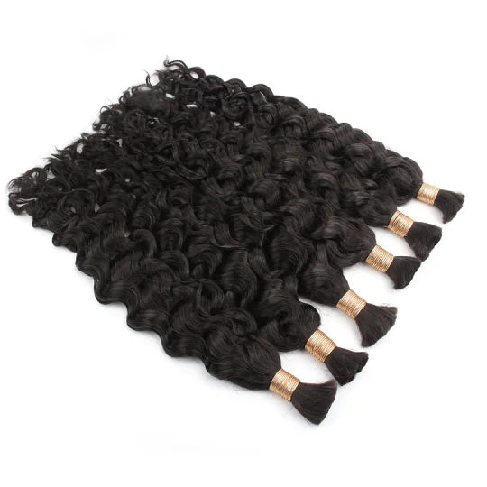 Latin wave bulk hair in dark black loose curls, flat lay with gold-tipped ends.