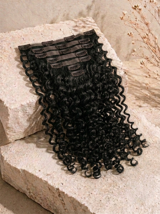 Dark brown curly clip-in hair extensions with visible clips at the top and dense curls