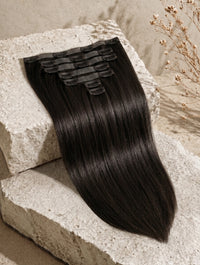 Seamless clip-in hair extensions bundle with straight jet-black hair and comb clips