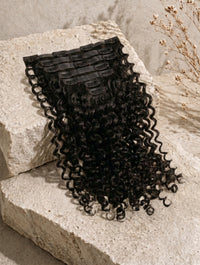 Seamless clip-in hair extensions bundle with curly black hair and comb clips