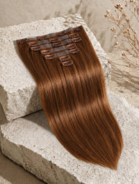 Chestnut brown clip-in hair extension weft with visible comb clips