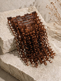 Curly dark brown clip-in hair extension weft with attached comb clips
