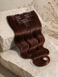 Dark brown wavy clip-in hair extension piece with comb clips