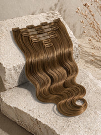 Seamless clip-in hair extensions worn, long body-wave hair in medium brown