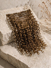Seamless clip-in hair extensions bundle with tight curls in medium brown