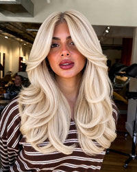 Seamless clip-in extensions with long body-wave layers, platinum silver blonde