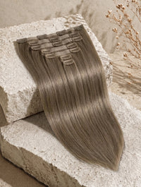 Straight clip-in hair weft sample in ashy brown tone with comb clips.