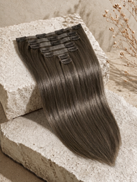 Jet black straight clip-in hair extension weft with multiple sewn-in comb clips