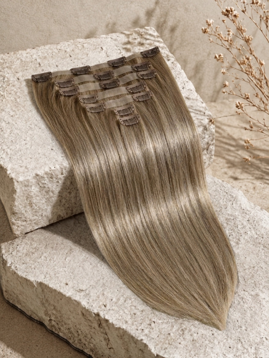 Clip-in hair extension weft in medium brown straight texture with attached snap clips