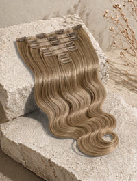 Seamless clip-in hair extensions with light brown body wave hair and metal snap clips
