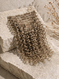 Beige blonde curly clip-in extensions with comb clips, loose ringlets