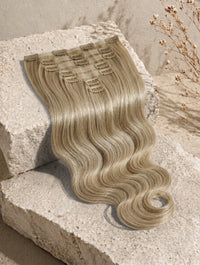 Beige blonde body-wave clip-in extensions with comb clips, long flowing waves